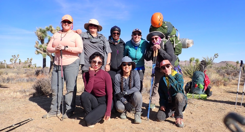 a group of veterans pose for a group photo in joshua tree